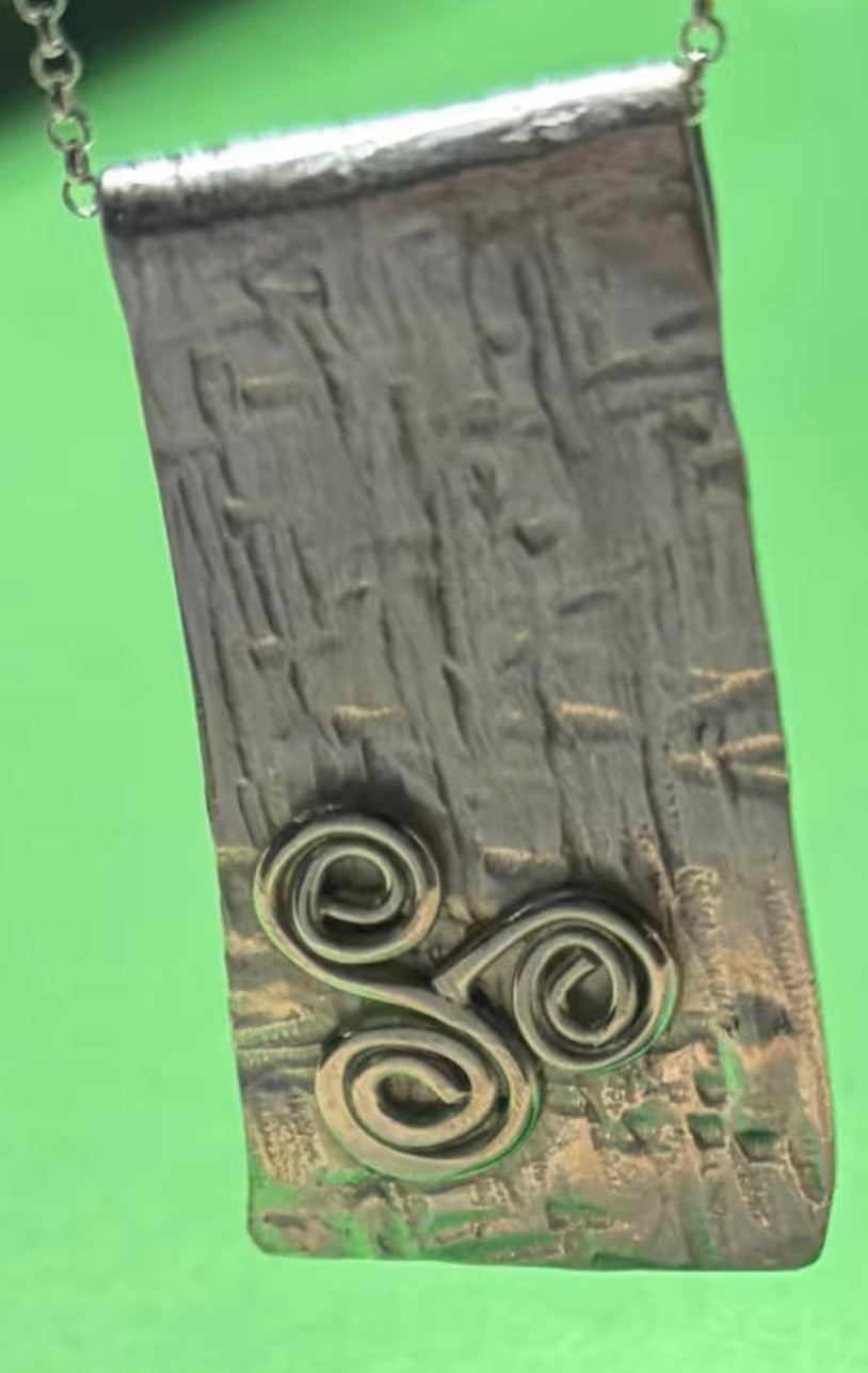 Handmade sterling silver triskele long pendant on an 18 inch necklace