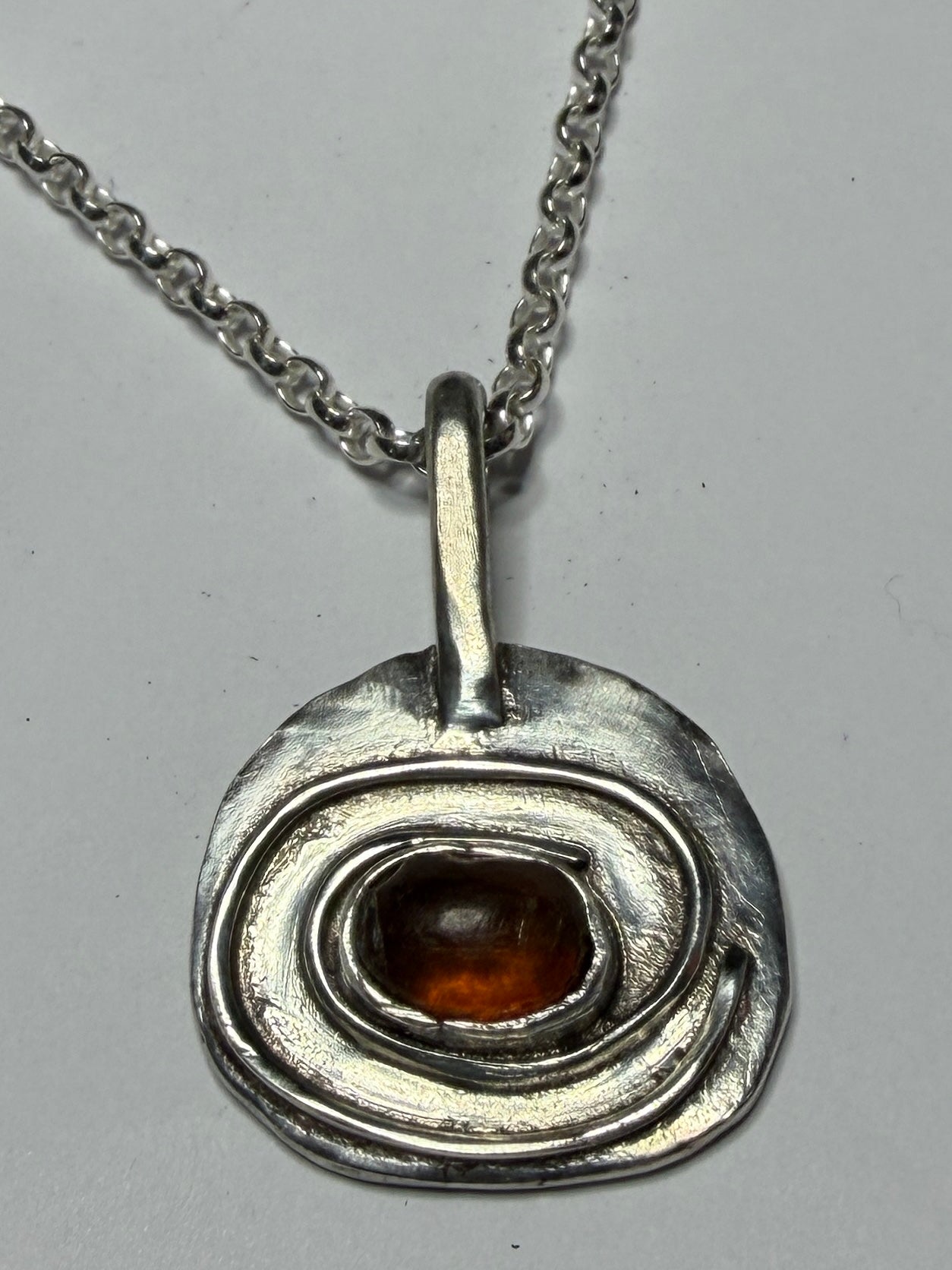 Sterling silver pendant with amber stone. Chain length options of 18 or 20 inches