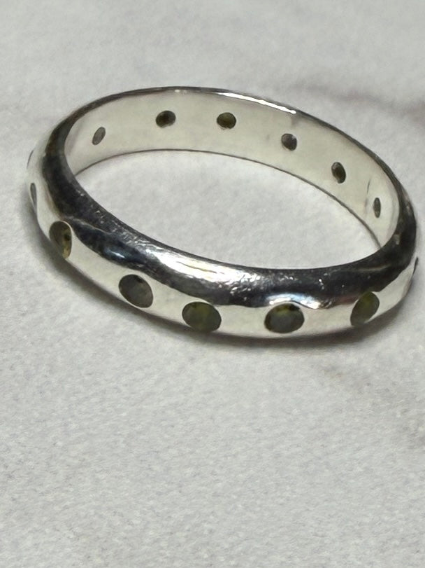 Handmade sterling silver ring with green flush set CZ stones. Size O