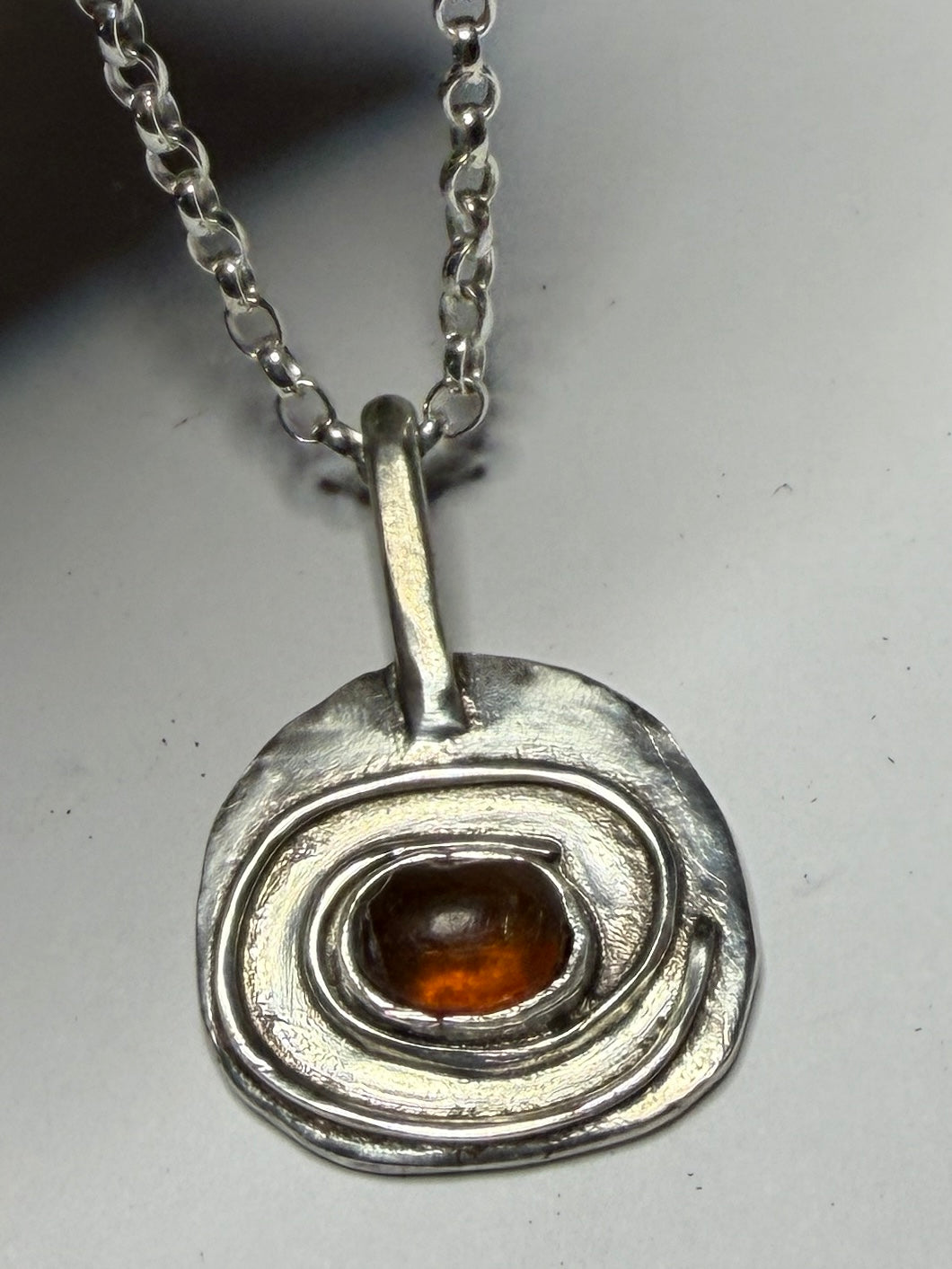 Sterling silver pendant with amber stone. Chain length options of 18 or 20 inches
