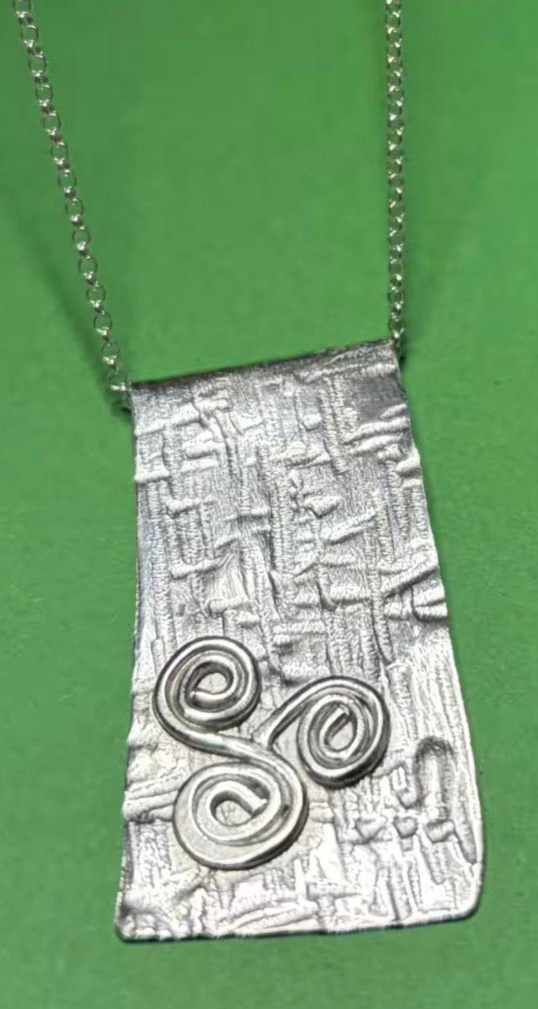 Handmade sterling silver triskele long pendant on an 18 inch necklace