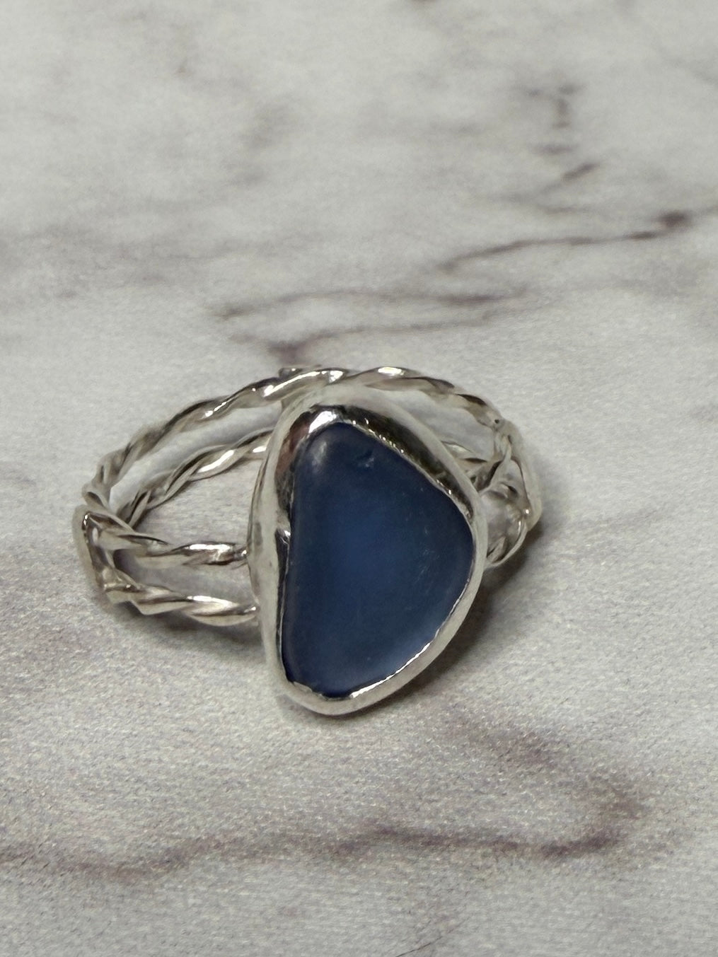 Handmade sterling silver double twist band with blue sea glass. Size S