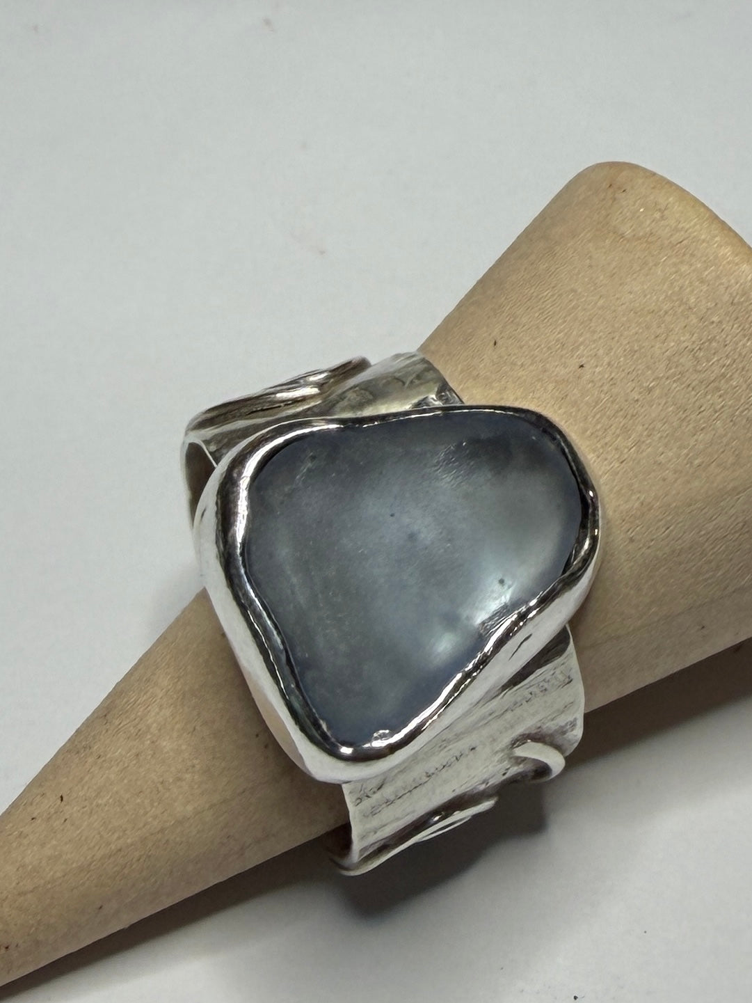 Handmade sterling silver swirl ring with blue sea glass. Size R