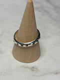 Handmade sterling silver ring with green flush set CZ stones. Size O
