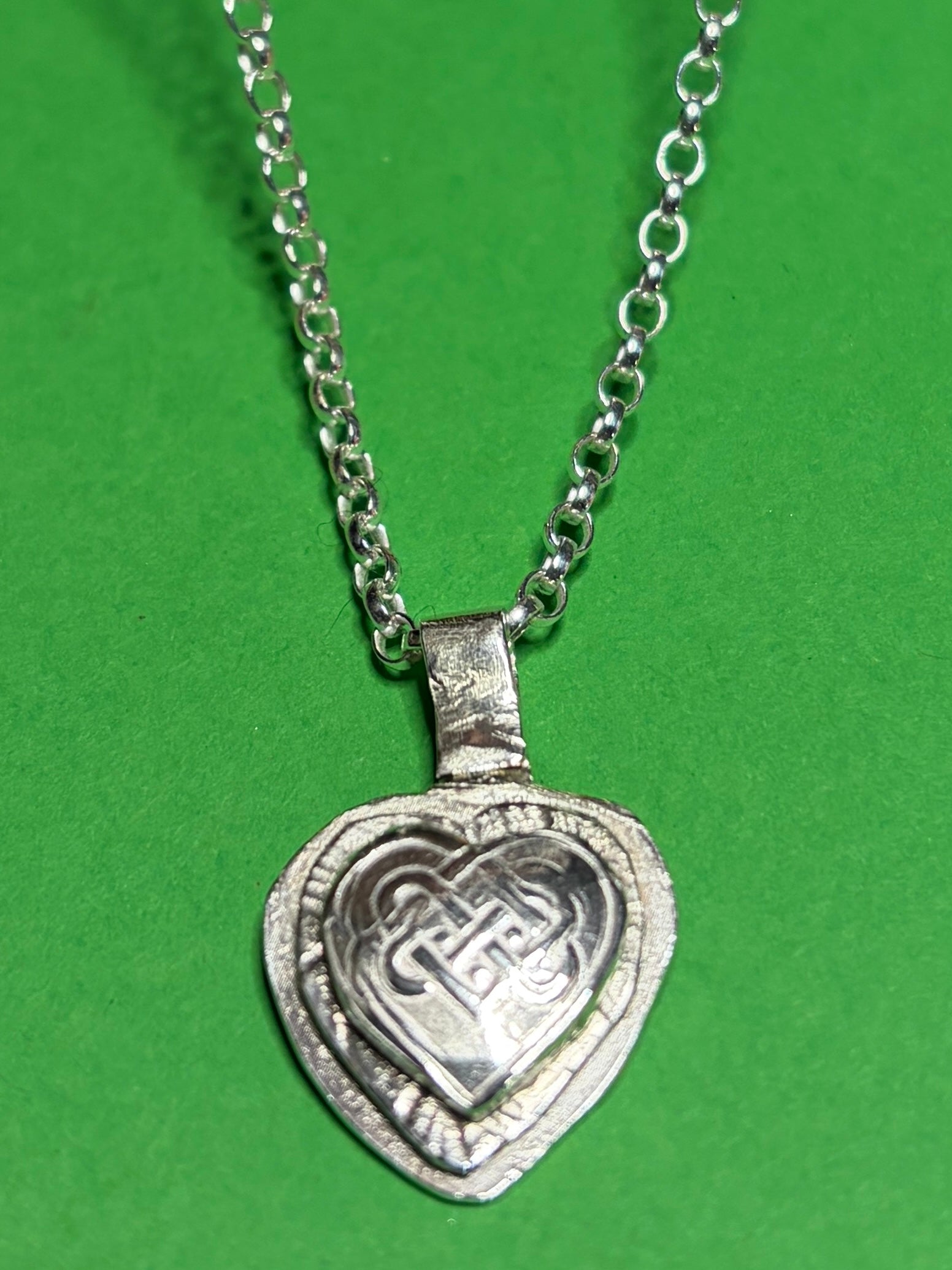 Handmade sterling silver Celtic heart with background on 18 or 20 inch chain.