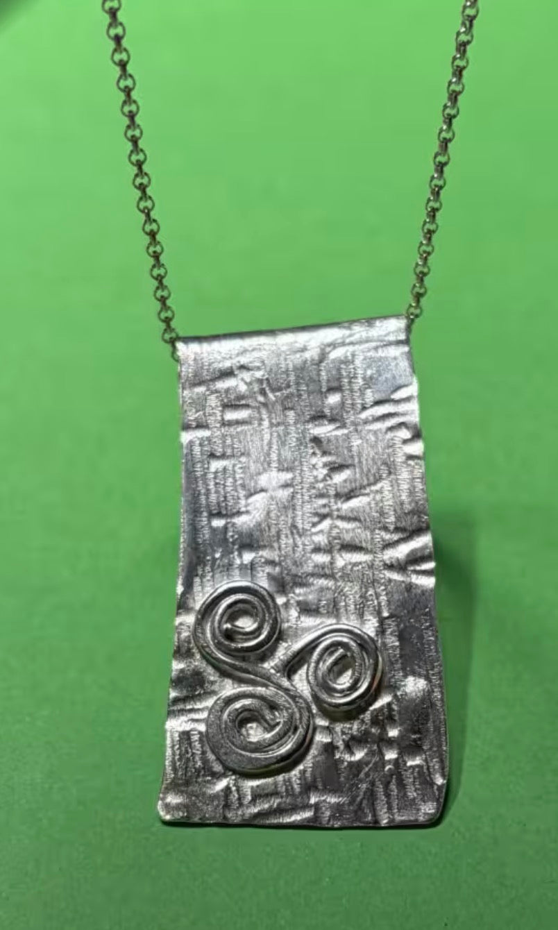 Handmade sterling silver triskele long pendant on an 18 inch necklace