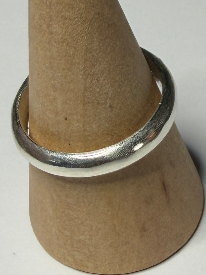 Handmade sterling silver ring with flush set stones. Purple stones and one clear. Size P