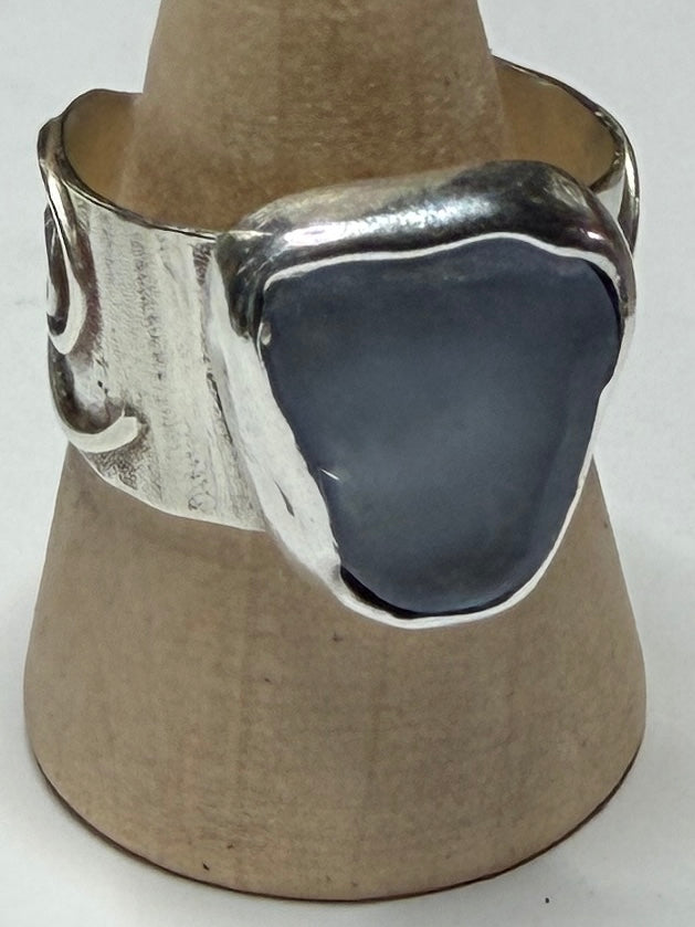 Handmade sterling silver swirl ring with blue sea glass. Size R
