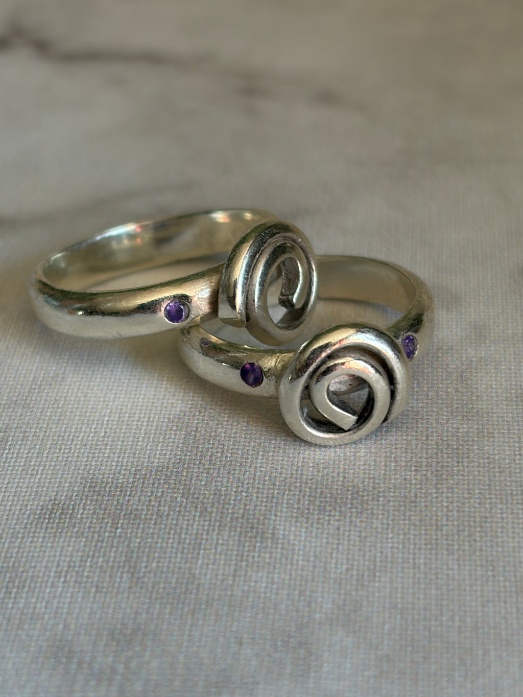 Handmade sterling silver Celtic swirl with purple flush set CZ stones